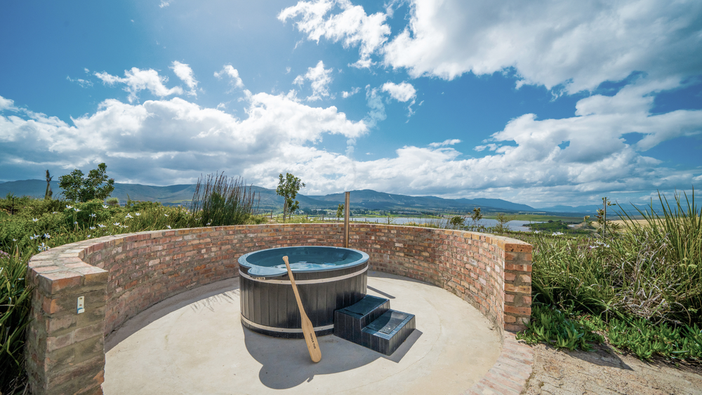 Wood-fired hot tub in the walled garden at Swallows Rest, a Hermanus wine estate villa