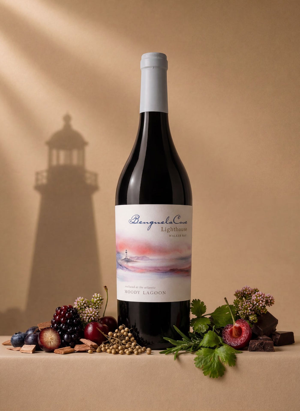 Bottle of Lighthouse Moody Lagoon red wine with a scenic label on a beige background with a lighthouse shadow.